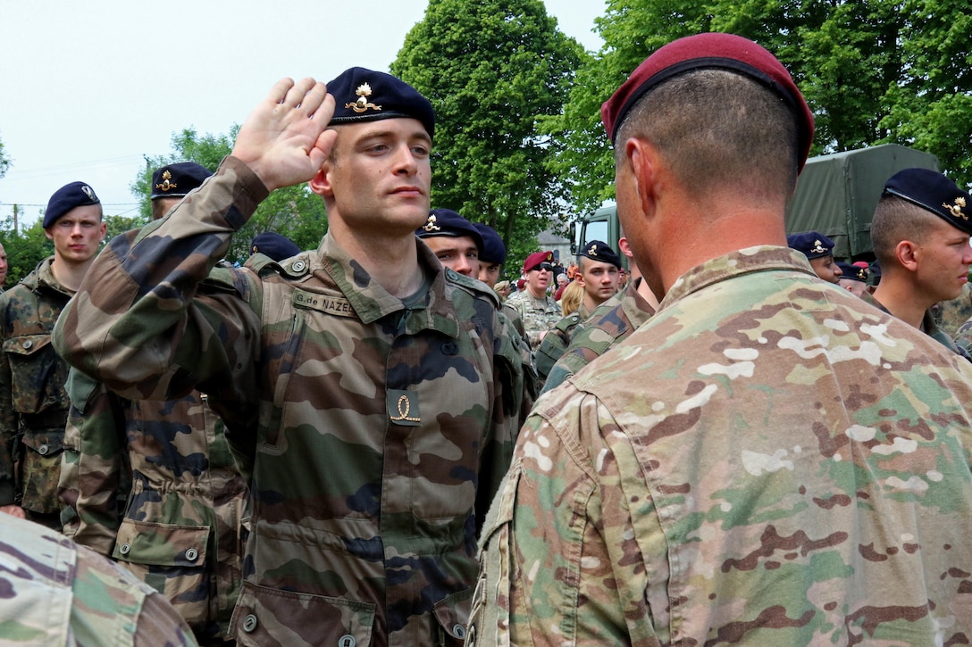 French paratroopers and members of the 82nd Airborne Division  exchange wings after jumping over Sainte Mere Eglise, France, June 5, 2016, to commemorate the 72nd anniversary of D-Day. U.S. Army photo by Capt. Joe Bush