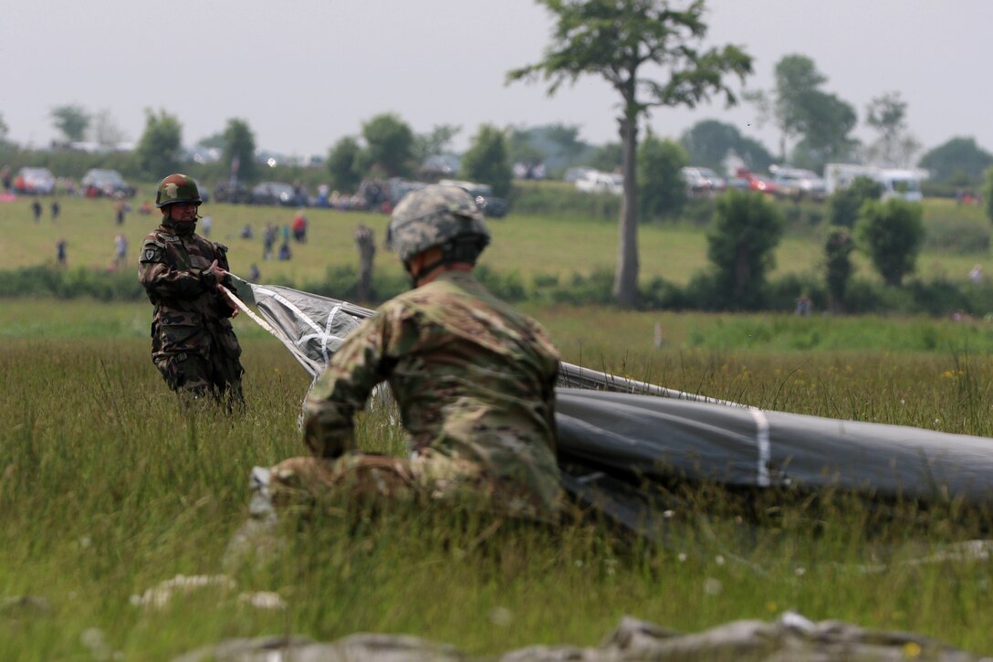 Paratroopers from France, Germany and America's 82nd Airborne Division complete their jump over Sainte Mere Eglise, France, June 5, 2016, to commemorate the 72nd anniversary of D-Day. U.S. Army photo by Capt. Joe Bush