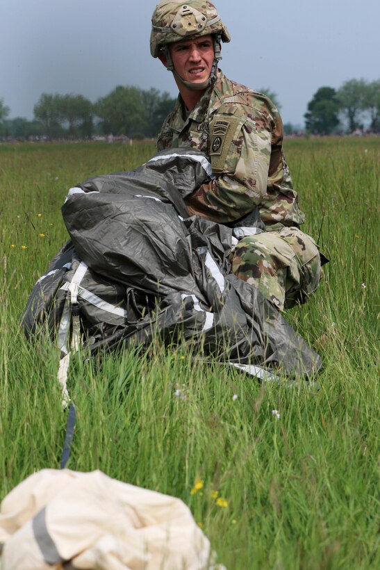 Paratroopers from France, Germany and America's 82nd Airborne Division walk off the drop zone together after their parachute jump over Sainte Mere Eglise, France on June 5, 2016, to commemorate the 72nd anniversary of D-Day. U.S. Army photo by Capt. Joe Bush