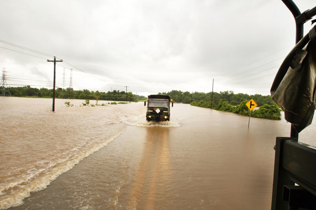 Soldiers drive their light multi-terrain vehicle into a flooded neighborhood to rescue stranded residents during severe flooding in Rosenberg, Texas, June 3, 2016. Texas Army National Guard photo by Staff Sgt. Timothy Pruitt