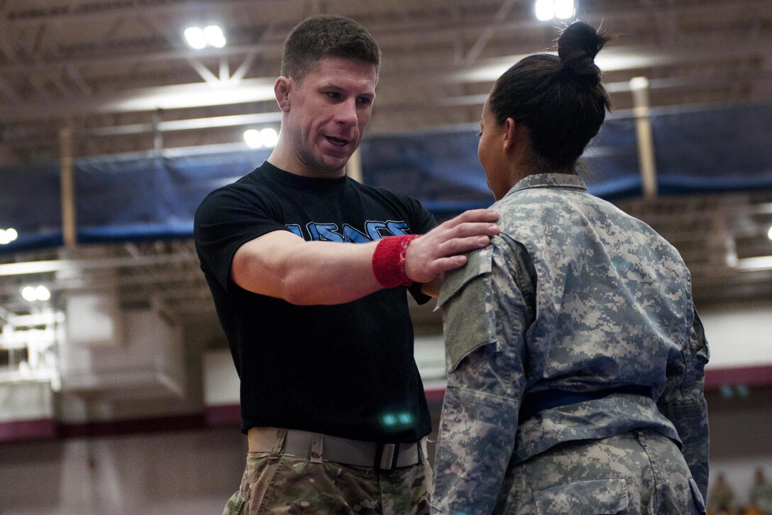 A referee, left, explains the rules to a competitor before she participates in the All American Week 2016 Combatives Tournament at Fort Bragg, N.C., May 24, 2016. Army photo by Staff Sgt. Adam C. Keith
