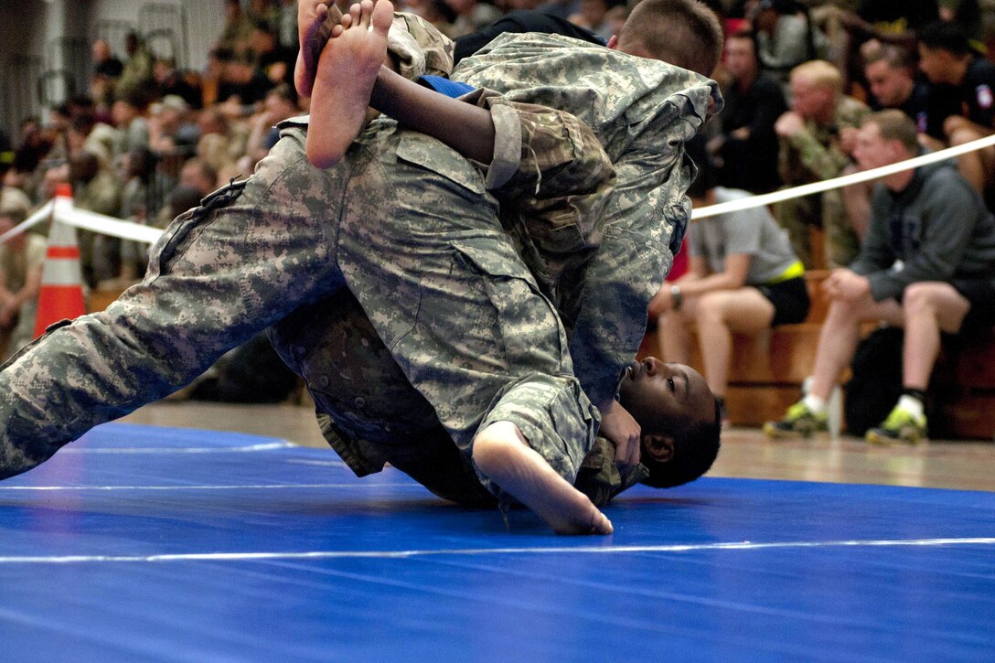 Army Spc. Darrick Jones, bottom, competes in the All American Week 2016 Combatives Tournament at Fort Bragg, N.C., May 24, 2016. Jones is a signal support specialist assigned to the 82nd Airborne Division’s Sustainment Brigade. Army photo by Staff Sgt. Adam C. Keith