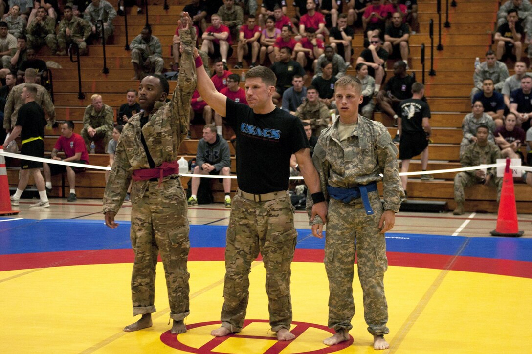 Army Spc. Darrick Jones, left, wins a match during the All American Week 2016 Combatives Tournament at Fort Bragg, N.C., May 24, 2016. Jones is a signal support specialist assigned to the 82nd Airborne Division’s Sustainment Brigade. Army photo by Staff Sgt. Adam C. Keith