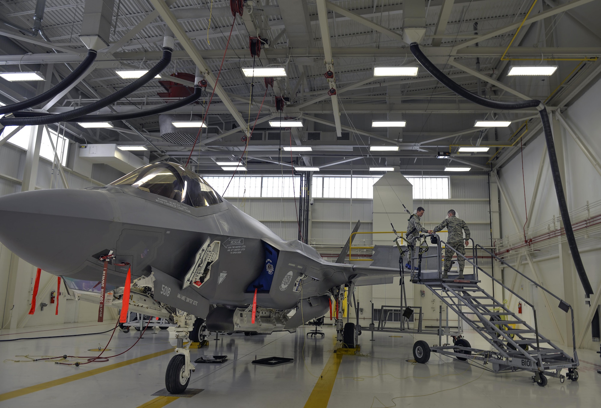 Airmen 1st Class Griffin Smith and William Manion, both 33rd Maintenance Squadron aircraft fuels system repairman apprentices, don safety gear to prepare an F-35A Lightning II for maintenance at Eglin Air Force Base, Fla., Jan. 13, 2016. Fuel systems Airmen work on top of the jets to remove, repair, inspect, install and modify aircraft fuel systems. (U.S. Air Force photo/Senior Airman Andrea Posey)