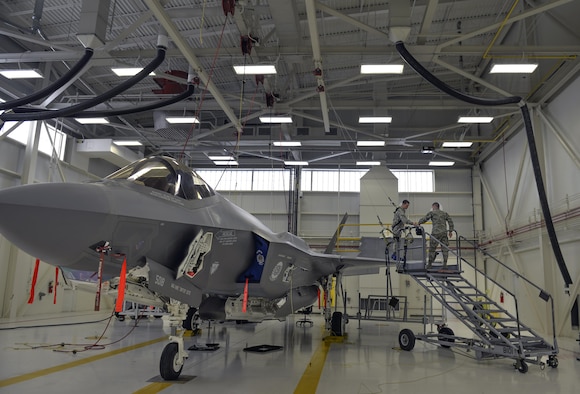 Airmen 1st Class Griffin Smith and William Manion, both 33rd Maintenance Squadron aircraft fuels system repairman apprentices, don safety gear to prepare an F-35A Lightning II for maintenance at Eglin Air Force Base, Fla., Jan. 13, 2016. Fuel systems Airmen work on top of the jets to remove, repair, inspect, install and modify aircraft fuel systems. (U.S. Air Force photo/Senior Airman Andrea Posey)