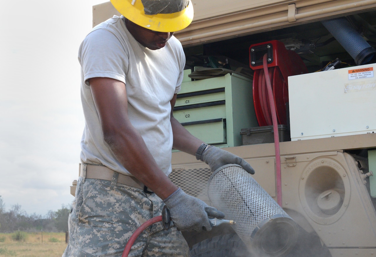 Army Pvt. Rhoen Barnes, a wheeled-vehicle mechanic attached to the Army Reserve’s 672nd Engineer Company, uses compressed air to clean an air filter during a construction project in the Kaweah Oaks Preserve at Exeter, Calif., May 24, 2016. Army photo by Sgt. Alfonso Corral