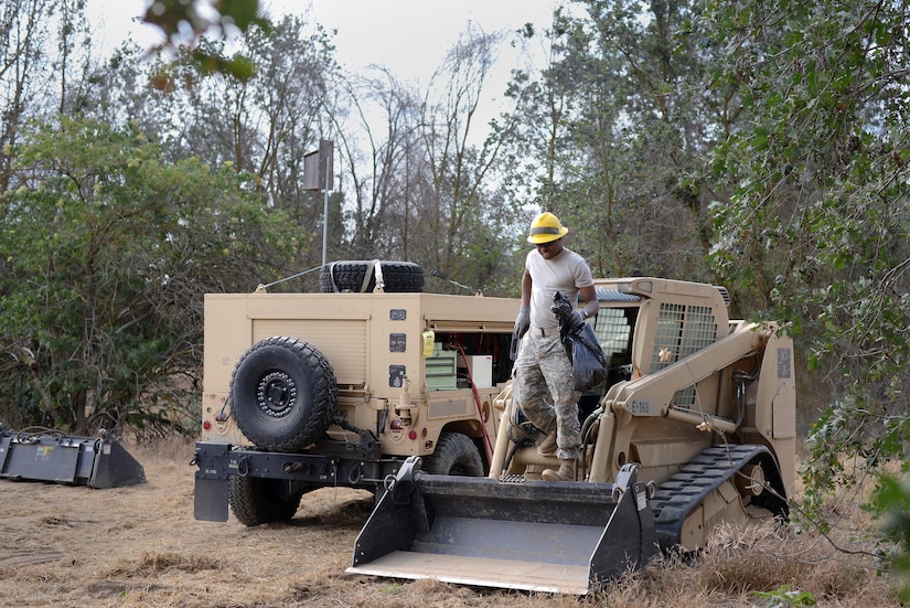 Army Pvt. Rhoen Barnes, a wheeled-vehicle mechanic attached to the Army Reserve’s 672nd Engineer Company, cleans a skid-steer loader in the Kaweah Oaks Preserve at Exeter, Calif., May 24, 2016. Army photo by Sgt. Alfonso Corral