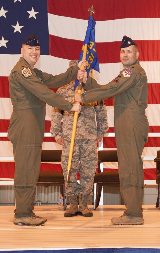 Lt. Col. Steven Sylvester, right, accepts the 33rd Flying Training Squadron guidon from Col. John Cinnamon, the 71st Operations Group commander, during a change-of-command ceremony June 2 in Hangar 170 at Vance Air Force Base, Oklahoma. Sylvester assumed command of the 33rd FTS from Lt. Col. Michael Starr. (U.S. Air Force photo by Tech. Sgt. James Bolinger)
