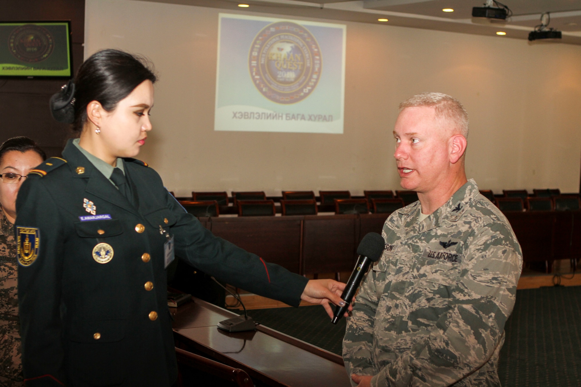 A Mongolian Armed Forces soldier interviews U.S. Air Force Col. Carl Magnusson, exercise co-director for Khaan Quest 16, after a media engagement at the Ministry of Defense, in Ulaanbatar, Mongolia, May 20, 2016. Khaan Quest is an annual, multinational peacekeeping operations exercise conducted in Mongolia and is the capstone exercise for this year's United Nations Global Peace Operations Initiative program. (U.S. Marine Corps photo by Cpl. Hilda M. Becerra / Released)
