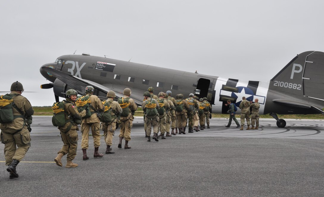 Father and daughter Liberty Jump Team members, Tom Lupu and Yvanna Sworobowicz, along with other team members board a C-47 for an exhibition jump into Graignes, France June 3, 2016 for the D-Day commemoration. More than 380 service members from Europe and affiliated D-Day historical units are participating in the 72nd anniversary as a part of Joint Task Force D-Day 72.  The Task Force,  based in Sainte-Mère-Église, France, is supporting local events across Normandy, from May 30 - 6 June, 2016 to commemorate the selfless actions by all of the allies on D-Day that continue to resonate 72 years later.  (U.S. Air Force photo by Master Sgt. Jessica L. Kendziorek)
