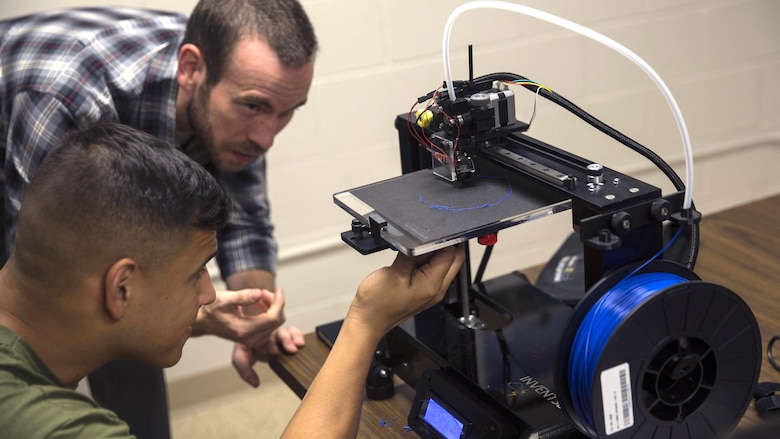 Justin Yates, an assistant professor at Francis Marion University, teaches the Marines about the capabilities of a 3D printer at Marine Corps Base Camp Lejeune, North Carolina, June 2, 2016. Additive manufacturing, or 3D printing, allows Marines to produce parts quickly, with exact specifications and at almost any location. 