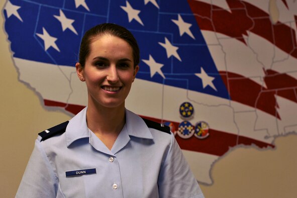 U.S. Air Force 1st Lt. Cassandra Dunn, 315th Training Squadron student, stands next to a decorated U.S. sign in Brandenburg Hall on Goodfellow Air Force Base, Texas, June 3, 2016. Dunn is the Goodfellow Student of the Month Spotlight for May, a series highlighting Team Goodfellow students. (U.S. Air Force photo by Airman 1st Class Caelynn Ferguson/Released)