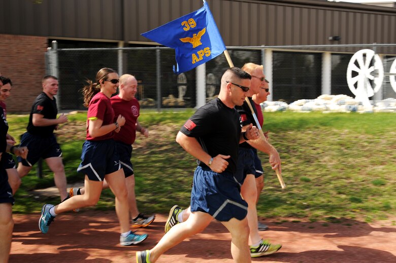 Members of the 39th Aerial Port Squadron run the annual Port Dawg Memorial Run, May 14, 2016 at Peterson Air Force Base, Colo. The 39th APS ran to pay tribute to transportation and logistics Reservists and to commemorate those currently serving, those who previously served and all fallen Port Dawg brothers and sisters. (U.S. Air Force photo/Staff Sgt. Amber Sorsek)