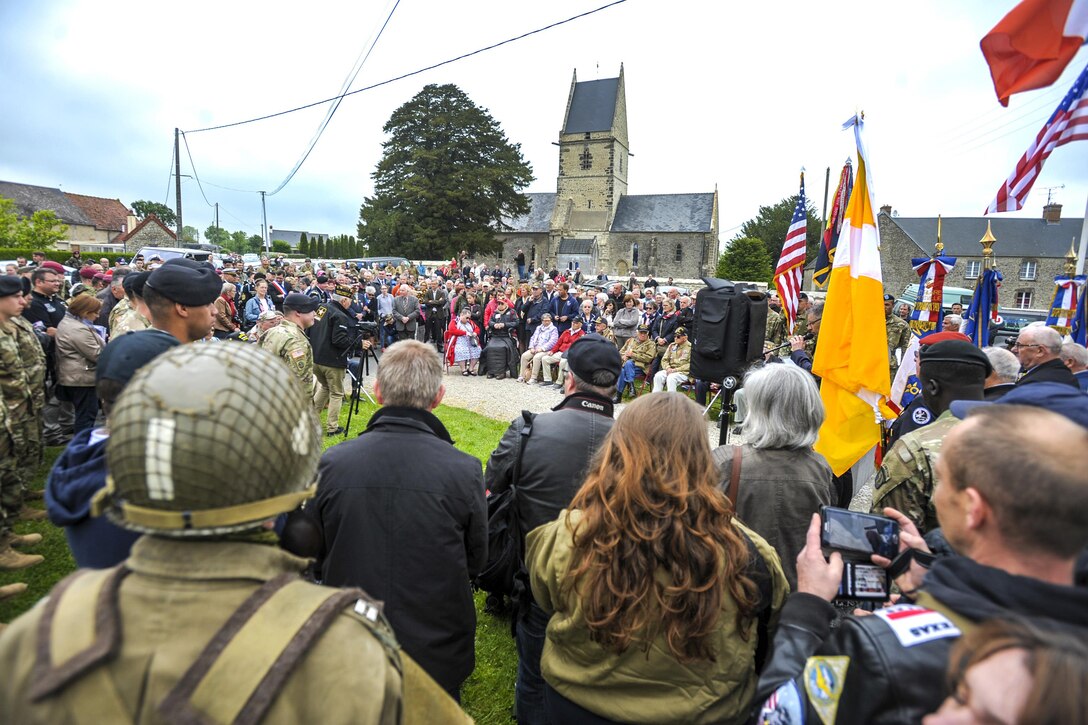 Soldiers, sailors, veterans and civilians gather for a memorial ceremony to honor U.S. Army veterans Kenneth Moore and Robert Wright in Angoville au Plain, France, June 4, 2016. Air Force photo by Staff Sgt. Timothy Moore