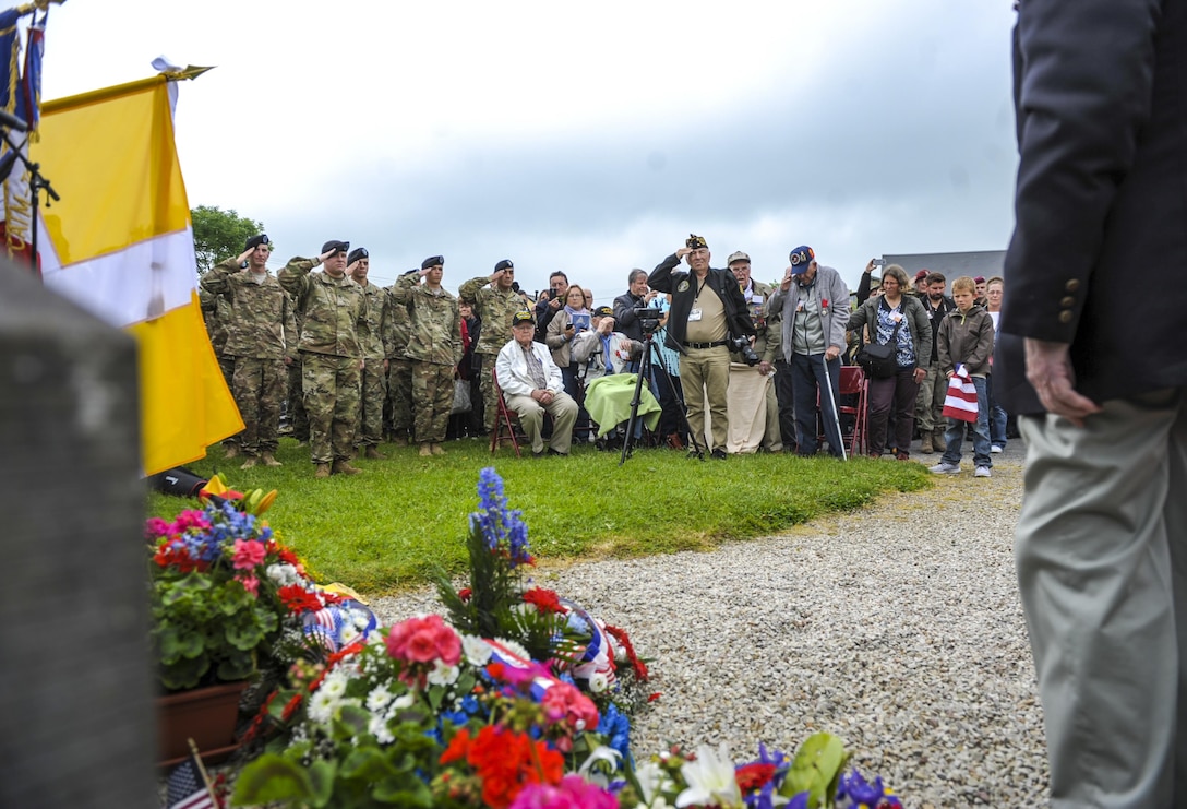 U.S., German and French service members, veterans and civilians pay their respects at the memorial dedicated to the actions displayed by U.S. Army veterans Kenneth Moore and Robert Wright during World War II at a memorial ceremony in Angoville au Plain, France, June 4, 2016. Air Force photo by Staff Sgt. Timothy Moore