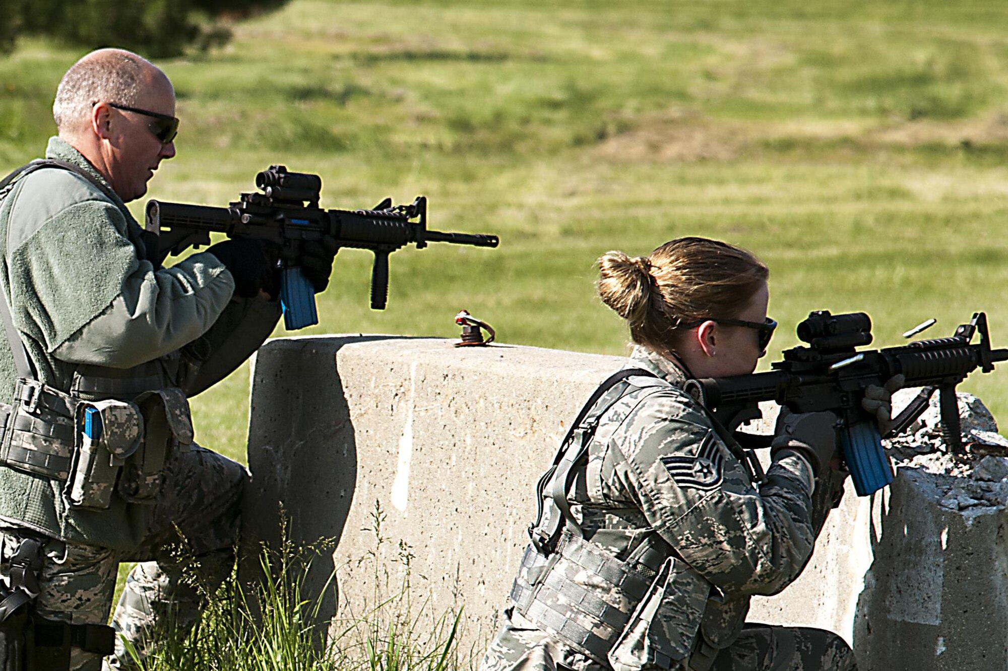 Tech. Sgt. Chris Fancher, 434th Security Forces Squadron fire team leader, and Staff Sgt. Julie Hazelett, 434th SFS fire team member, use simulated munition rounds during a live fire exercise May 15, 2016 at Grissom Air Reserve Base, Ind. The simulated munition rounds are designed to be nonlethal allowing SFS members to simulate real world firefights with less risk of injury. (U.S. Air Force photo/Senior Airman Dakota Bergl)