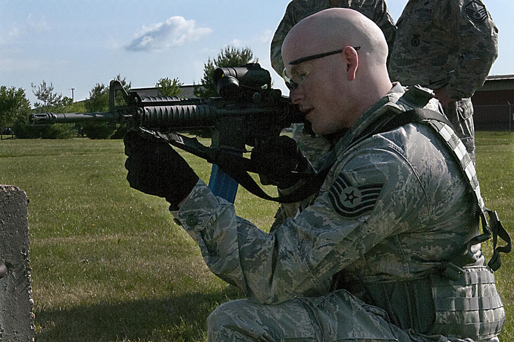 Tech. Sgt. Preston Geimer, 434th Security Forces Squadron fire team leader, aims his weapon during a shoot, move, communicate exercise May 15, 2016 at Grissom Air Reserve Base, Ind. The weapons used during the exercise were outfitted with special bolt assemblies allowing them to fire simulated munition rounds. (U.S. Air Force photo/Senior Airman Dakota Bergl)