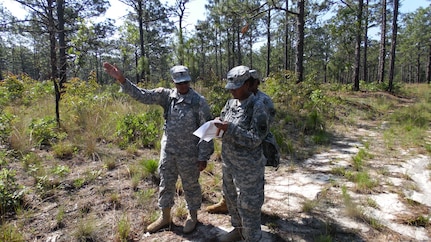 Soldiers assigned to the U.S. Army Reserve Augmentation Unit (UAU) determine the correct direction to one of several points for a land navigation and orienteering exercise during their Battle Assembly on June 4, 2016, at Fort Bragg, N.C. The training involved movement to the training are via U.S. Army Reserve UH-60 Black Hawk helicopters then navigating to fixed points using a map, compass and protractor. The mission of the UAU is to augment United States Army Reserve Command staff during exercises, crisis actions, or a presidential selective reserve call-up. Soldiers of the UAU train regularly to provide the most qualified, trained, and prepared Soldiers upon request by Army units. (U.S. Army photo by Lt. Col. Kristian Sorensen/released)