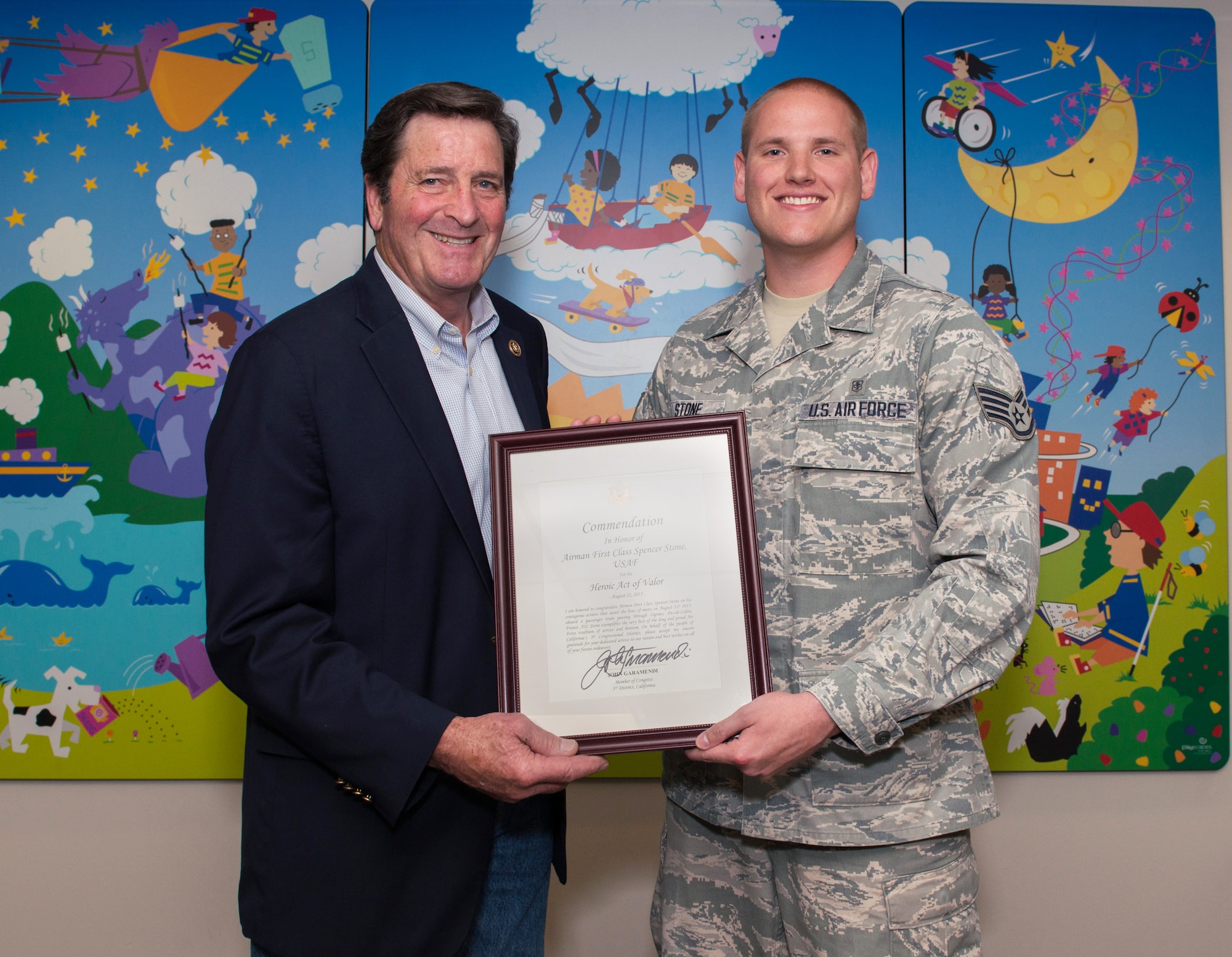 Rep. John Garamendi, D-Walnut Grove, Calif., presents Staff Sgt. Spencer Stone, 60th Medical Operations Squadron pediatric medical technician, with a Certificate of Commendation at Travis Air Force Base, Calif., June 3, 2016. Stone garnered international headlines in August 2015 when he and two friends thwarted a terrorist attack on a Paris-bound train, subduing and disarming a man wielding an assault rifle, pistol and box cutter. Exposing himself to the man's line of fire, Stone charged, tackled and restrained the individual. During the struggle, the gunman slashed Stone several times lacerating his head, neck, and thumb. Despite his injuries, Stone then provided life-saving care to a man who received a gunshot wound to his throat during the attack. Stone applied pressure to the wounded man's neck to stop the life-threatening bleeding. For his heroic and selfless actions, Stone was presented with France's highest recognition, the Legion of Honor. (U.S. Air Force photo by Louis Briscese/Released)