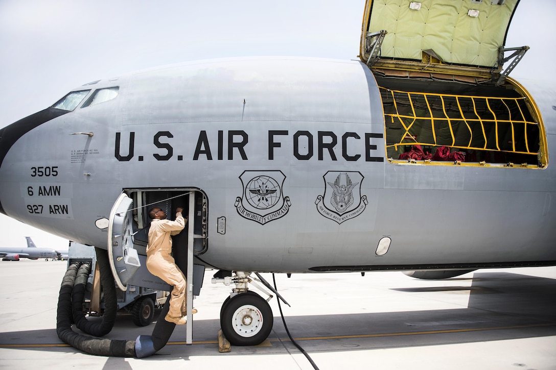 Senior Airman Darhon Hambrick boards a KC-135 Stratotanker aircraft as part of a refueling mission at Al Udeid Air Base, Qatar, May 31, 2016. Hambrick is a boom operator assigned to the 340th Expeditionary Air Refueling Squadron. Air Force photo by Staff Sgt. Larry E. Reid Jr.