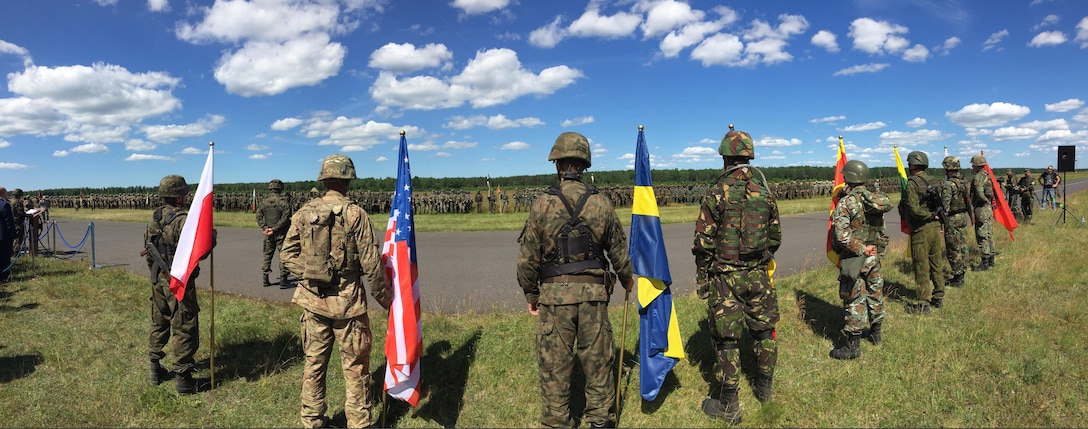 Soldiers from eight nations display their national flags during an opening ceremony for Exercise Anakonda 2016 at the Drawsko Pomorskie Training Area, Poland, June 6. Exercise Anakonda 2016 is a Polish-led, joint multinational exercise taking place throughout Poland June 7-17. The exercise involves approximately 31,000 participants from more than 20 nations. Exercise Anakonda 2016 is a premier training event for U.S. Army Europe and participating nations and demonstrates the United States and partner nations can effectively unite under a unified command while training on a contemporary scenario. (U.S. Army photo by Timothy L. Hale) (Released) (This image was made with an iPhone panorama app)