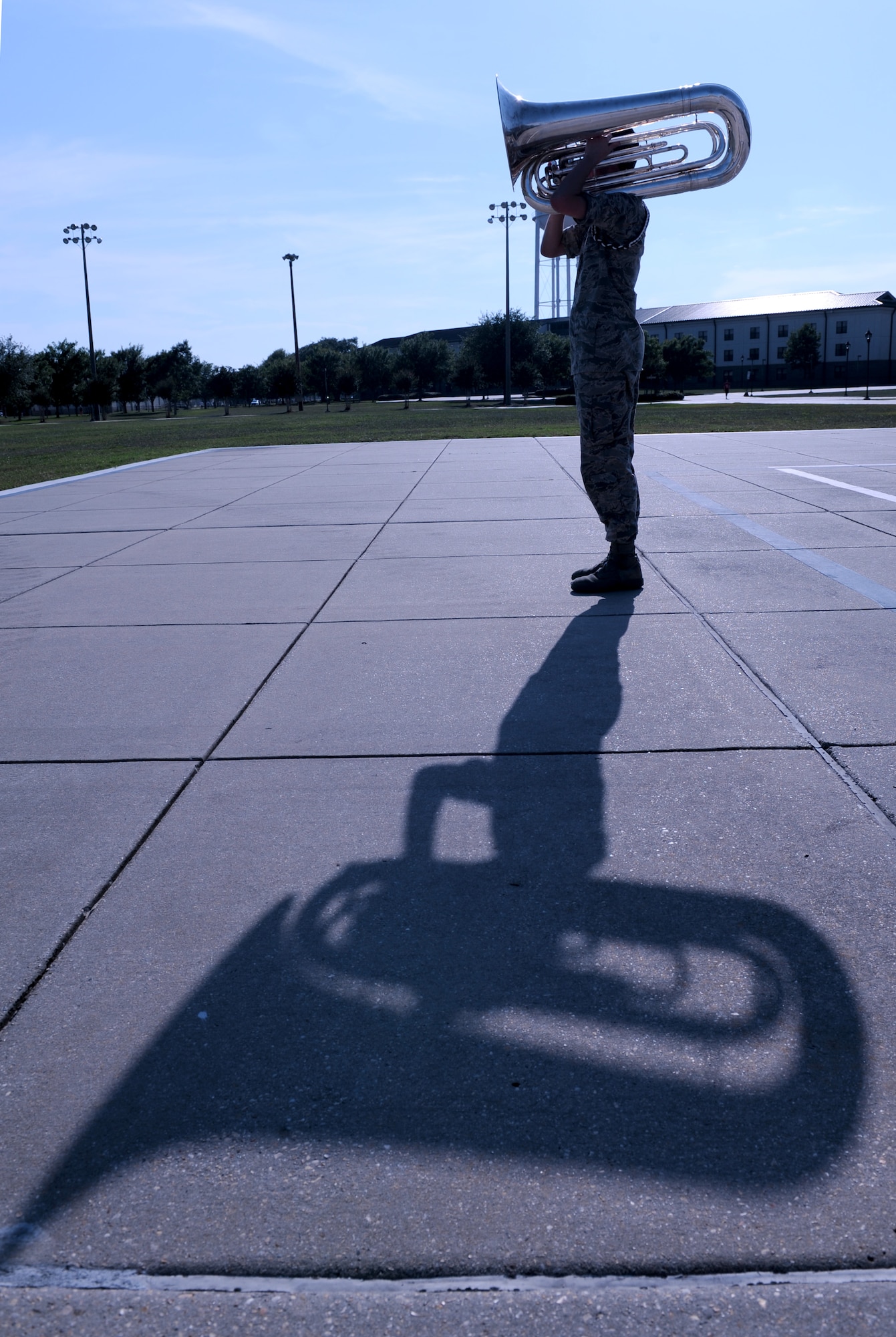 Airman 1st Class Nicolas Overton, 81st Training Wing Drum and Bugle Corps tuba player, plays a musical piece during a practice session on the drill pad at the Levitow Training Support Facility May 31, 2016, Keesler Air Force Base, Miss. The drum and bugle corps performs at various events such as 81st Training Group student parades and drill downs in addition to attending Air Force specialty code technical training on a daily basis. (U.S. Air Force photo by Kemberly Groue)