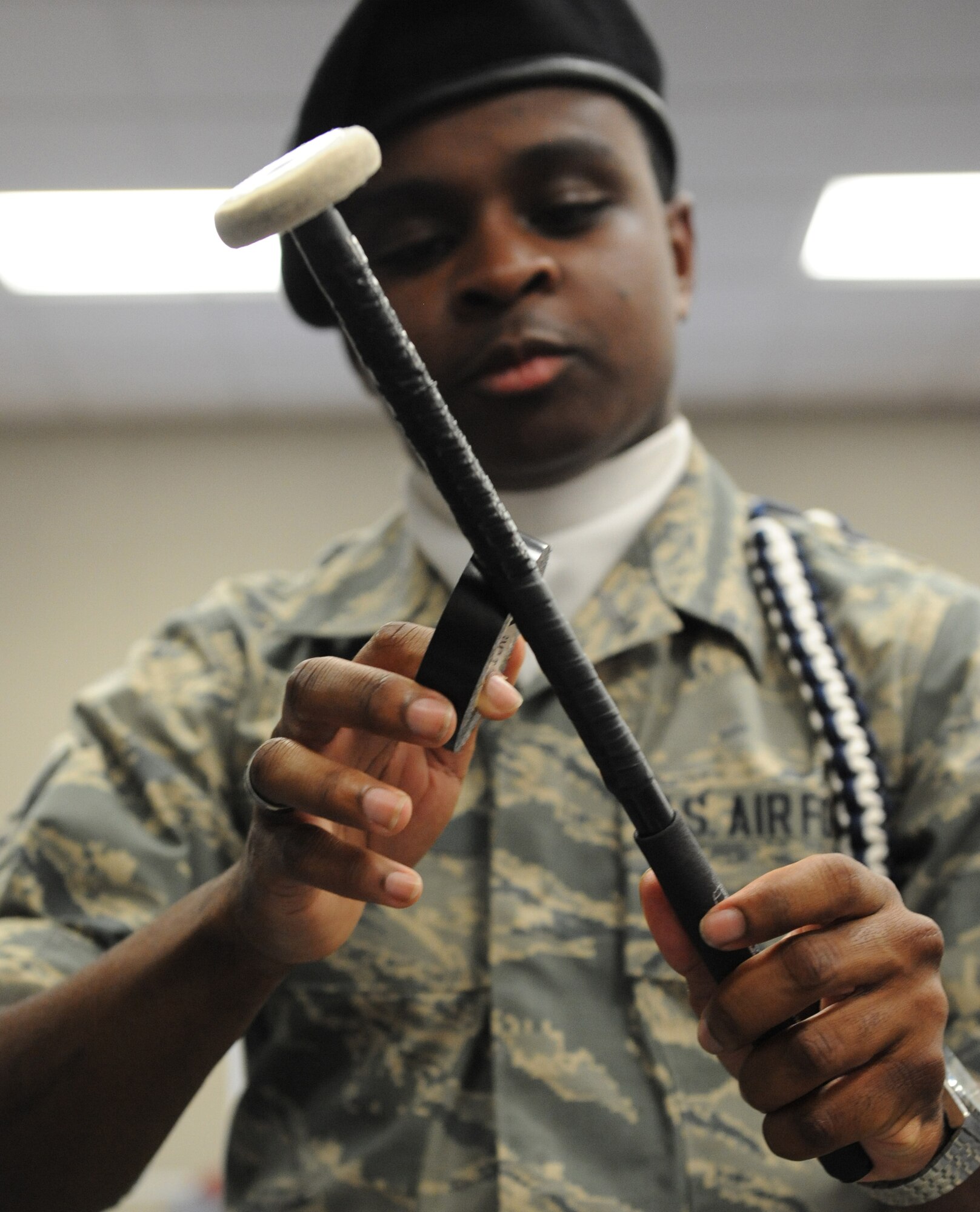 Airman 1st Class Jacari Davis, 81st Training Wing Drum and Bugle Corps snare drum player, repairs the tape on his drum mallets during a practice session at the Levitow Training Support Facility May 31, 2016, Keesler Air Force Base, Miss. The drum and bugle corps performs at various events such as 81st Training Group student parades and drill downs in addition to attending Air Force specialty code technical training on a daily basis. (U.S. Air Force photo by Kemberly Groue)