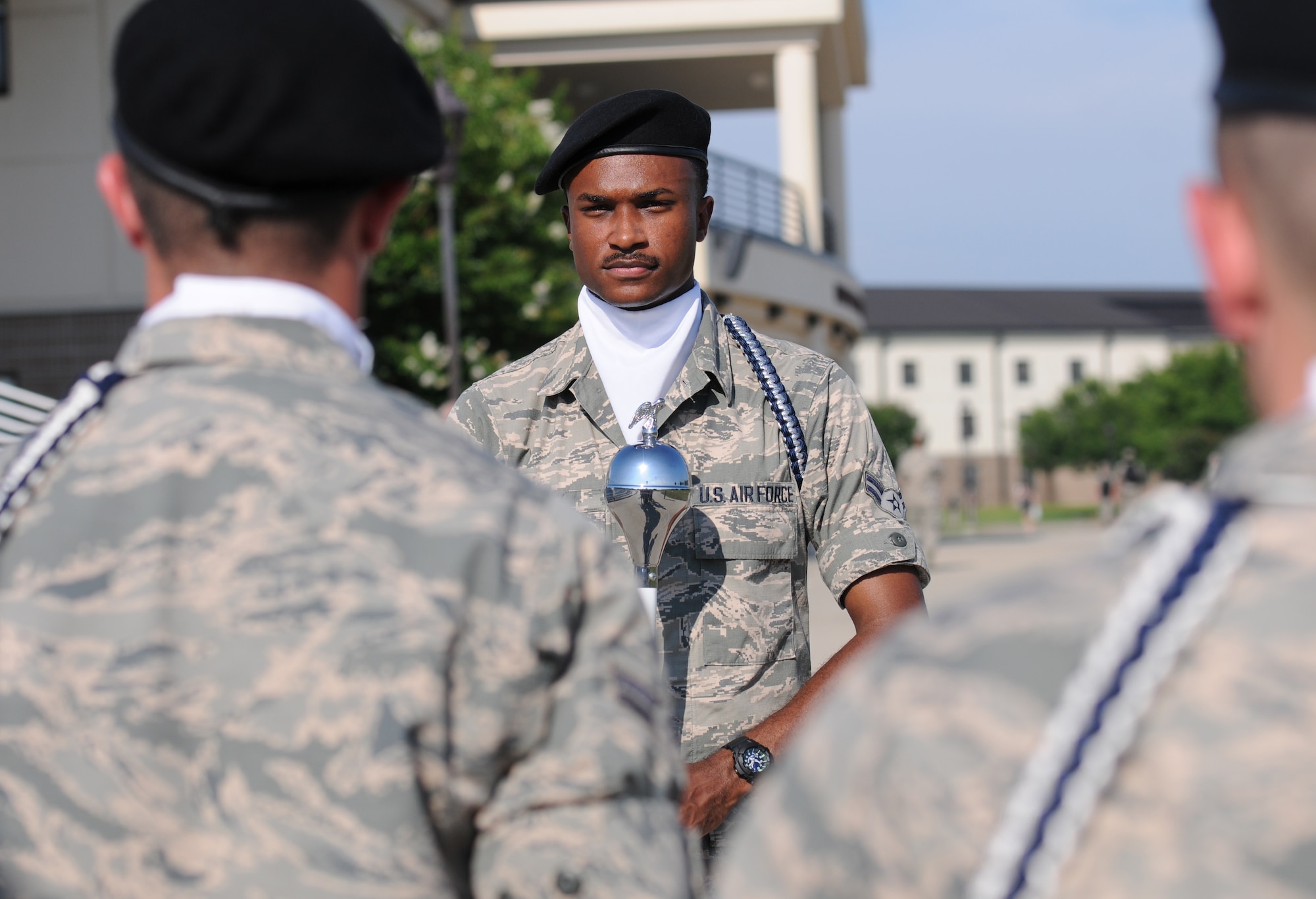 Airman 1st Class Evan Mack, 81st Training Wing Drum and Bugle Corps drum major, leads the band onto the drill pad at the Levitow Training Support Facility during a practice session May 31, 2016, Keesler Air Force Base, Miss. The drum and bugle corps performs at various events such as 81st Training Group student parades and drill downs in addition to attending Air Force specialty code technical training on a daily basis. (U.S. Air Force photo by Kemberly Groue)