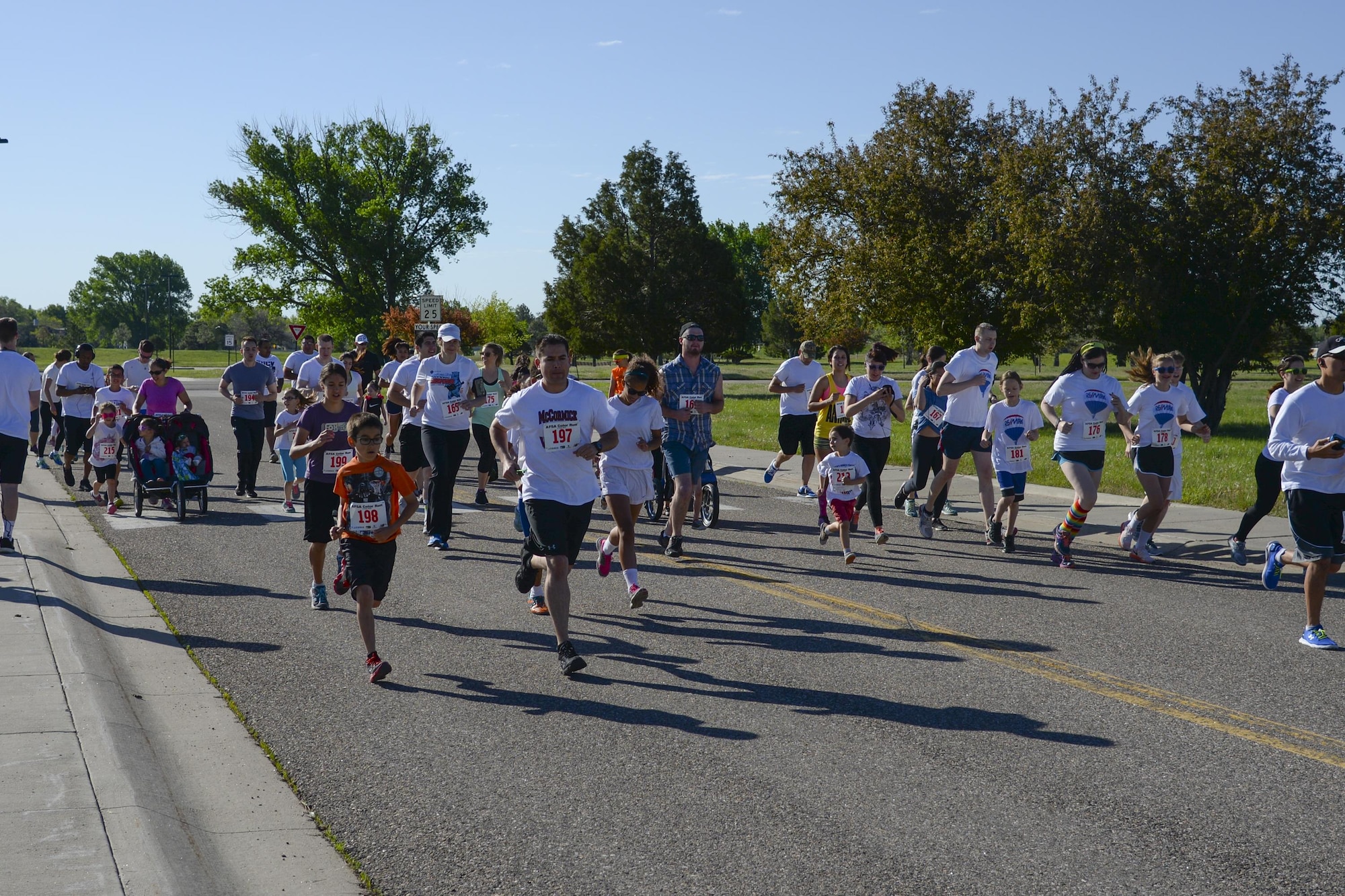 Runners take off from the start of the Air Force Sergeants Association Chapter 1178 Color Run on F.E. Warren Air Force Base, Wyo., June 4, 2016. While the runners ran, volunteers threw colored-chalk powder, covering their clothes and faces. (U.S. Air Force photo by Senior Airman Jason Wiese)