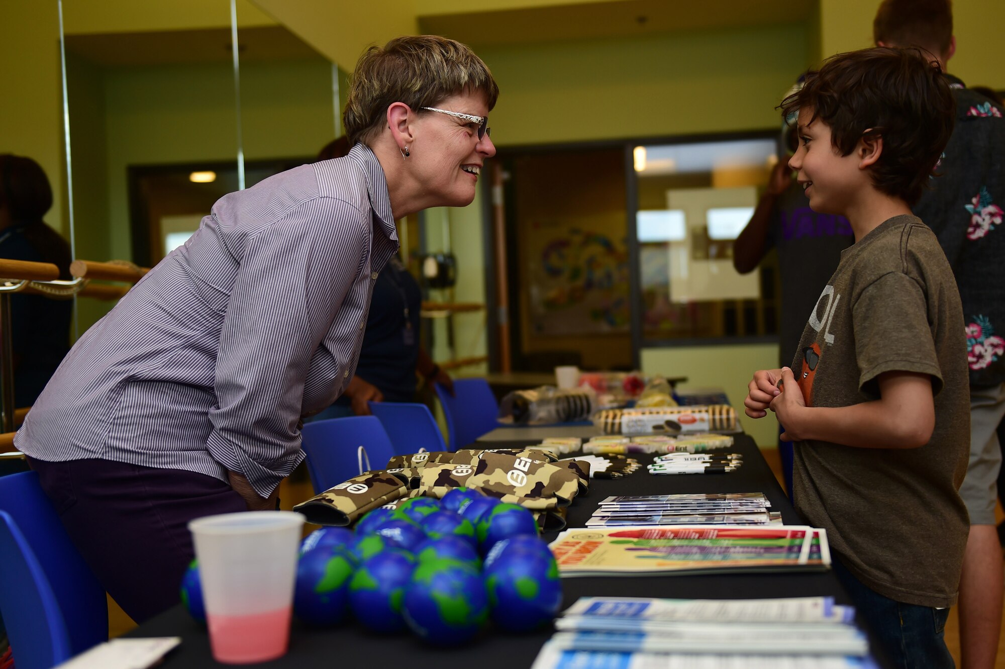 Sue Kimball, Ent Credit Union lending consultant, speaks with Kai Kurtz, a Buckley Air Force Base youth, June 3, 2016, during a College and Career Expo at the youth center on Buckley AFB, Colo. The expo educated Buckley AFB’s youth on the benefits of saving money at an early age and the different options available to them. (U.S. Air Force photo by Airman 1st Class Gabrielle Spradling/Released)