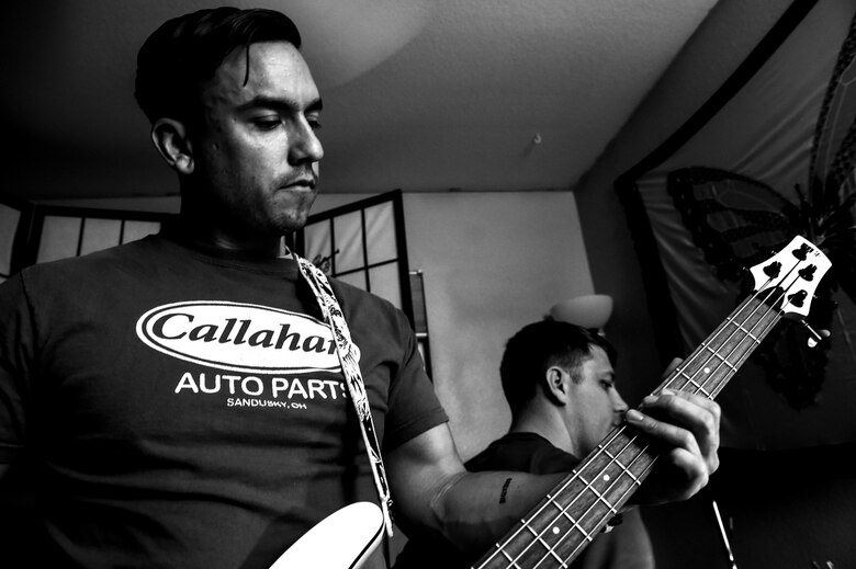 Tech. Sgt. James, 78th Attack Squadron, intelligence formalized training unit NCO in-charge, plays the guitar during a band rehearsal June 2, 2016 in Las Vegas. James is part of a five man group consisting of two guitarists, a drummer, a saxophonist and a vocalist. The band often plays music at military ceremonies and events hosted for other Airmen assigned to the 432nd Wing/432nd Air Expeditionary Wing. (U.S. Air Force photo by Senior Airman Adarius Petty)