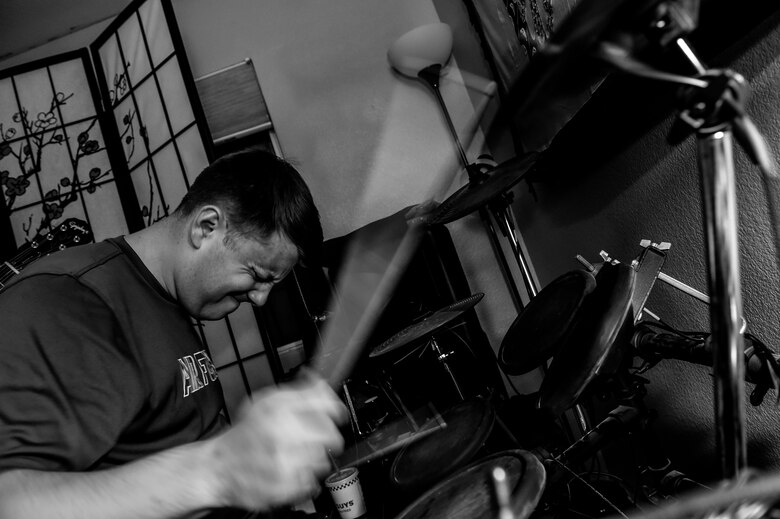 Senior Airman Dylan, 42nd Attack Squadron sensor operator, plays the drums during his free time as part of a five man group consisting of two guitarists, a drummer, a saxophonist and a vocalist. The band often plays for other Airmen assigned to the 432nd Wing/432nd Air Expeditionary Wing at Creech Air Force Base, Nevada during military ceremonies and events. (U.S. Air Force photo by Senior Airman Adarius Petty)