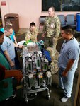 Tripler Army Medical Center staff make final adjustments to a ventilator carrying a very sick infant to a pediatric cardiologist in San Diego.