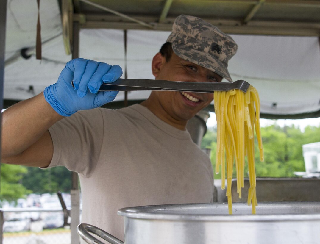 Sgt. Bishal Pandey, a culinary specialist assigned to the 200th Military Police Command, prepares lunch on the unit's Mobile Kitchen Trailer (MKT) during battle assembly at Fort Meade, Maryland, on June 4, 2016. The command’s goal is to have each of its units become proficient with their MKT so when they have to mobilize they are ready and prepared to use it. (U.S. Army photo by Spc. Stephanie Ramirez) 