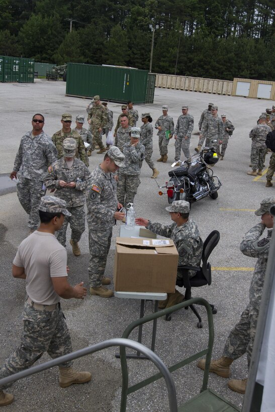 Soldiers assigned to the 200th Military Police Command line up to get lunch from their unit's Mobile Kitchen Trailer (MKT) during battle assembly at Fort Meade, Maryland, on June 4, 2016. The command’s goal is to have each of its units become proficient with their MKT so when they have to mobilize they are ready and prepared to use it. (U.S. Army photo by Spc. Stephanie Ramirez) 