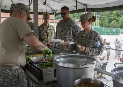 Culinary specialists assigned to the 200th Military Police Command take out their Mobile Kitchen Trailer (MKT) and prepare lunch during the unit’s battle assembly at Fort Meade, Maryland, on June 4, 2016. The command’s goal is to have each of its units become proficient with their MKT so when they have to mobilize they are ready and prepared to use it. (U.S. Army photo by Spc. Stephanie Ramirez) 
