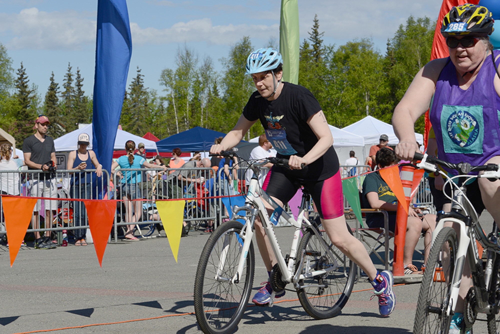 Senior Master Sgt. Tracie Timmerman, 673d Force Support Squadron Manpower and Personnel Flight superintendent, transitions to the bike during the Gold Nugget Triathlon at Bartlett High School, Alaska, May 15, 2016. The all-women’s triathlon consisted of a 500-yard lap swim, 12-mile biking trail and 4.1-mile run. Timmerman finished the triathlon in 3 hours, 4 minutes, 31 seconds. (U.S. Air Force photo by Airman 1st Class Christopher R. Morales)