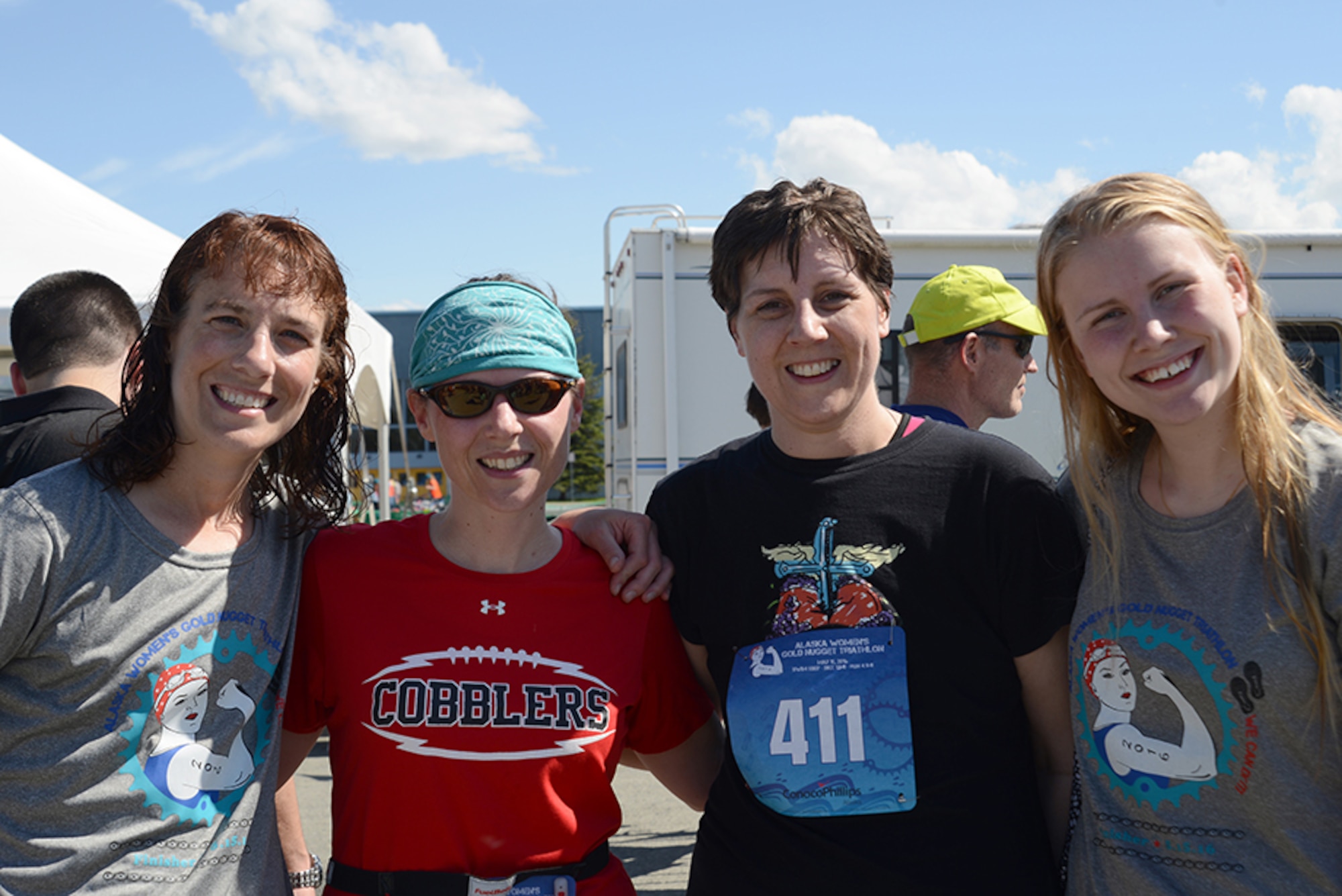 Anchorage Young Cancer Coalition members, Tracie Timmerman (right), Heidi Voeller (left), Carey Carpenter (far left), the founder, and her foreign exchange student Sophia (far right) finish the Gold Nugget Triathlon at Bartlett High School, Alaska, May 15, 2016. The all-women’s triathlon consisted of a 500-yard lap swim, 12-mile biking trail and 4.1-mile run. Timmerman finished the triathlon in 3 hours, 4 minutes, 31 seconds. (U.S. Air Force photo by Airman 1st Class Christopher R. Morales)