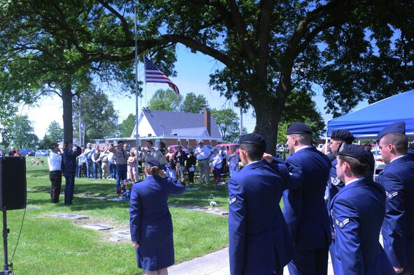 Members of the 509th Security Forces Squadron (SFS) render a salute as veterans and community members show their respects while an American Flag is lowered during the Whiteman Wreath Laying Ceremony at Memorial Park Cemetery in Sedalia, Mo., May 21, 2016. The 509th SFS is partnered with Sedalia in the Whiteman Air Force Base Community Council and participates in this annual event honoring 2nd Lt. George Whiteman, the namesake of Whiteman Air Force Base. (U.S. Air Force photo by 2nd Lt. Matthew Van Wagenen)