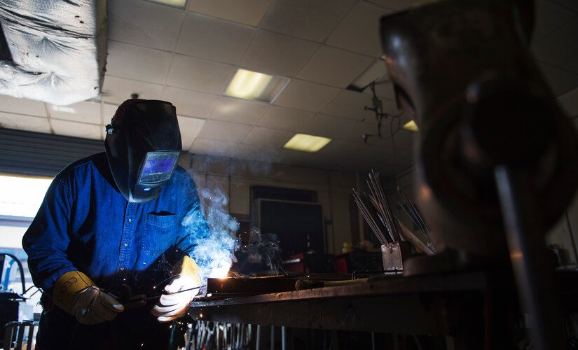 Kenny Mines, 11th Civil Engineer Squadron steel welder fabricator, welds a metal support together in the metal workshop on Joint Base Andrews, Md., June 1, 2016. The structures section of 11th CES does preventive maintenance, lock jobs and repairs throughout base. (U.S. Air Force photo by Airman 1st Class Philip Bryant)