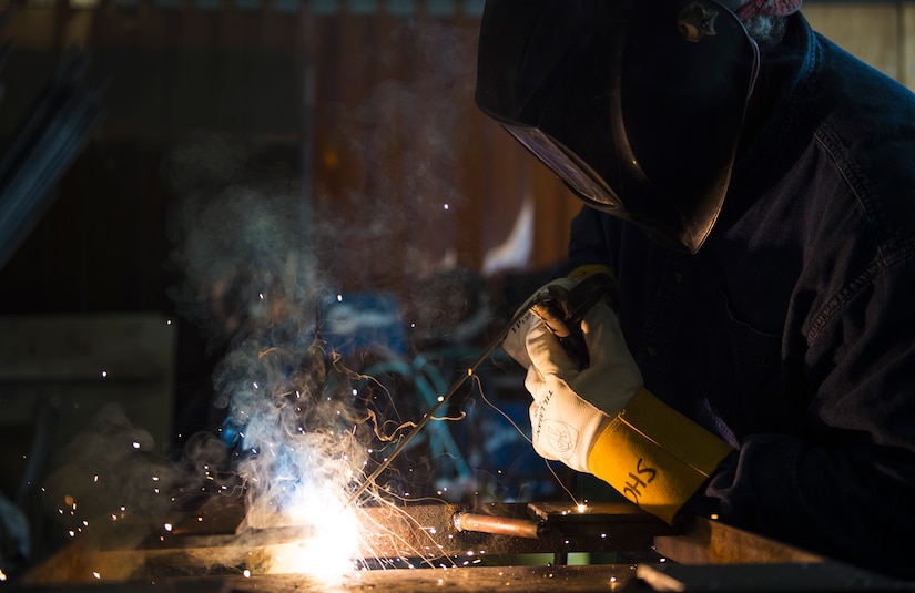 Kenny Mines, 11th Civil Engineer Squadron steel welder fabricator, welds a metal support together in the metal workshop on Joint Base Andrews, Md., June 1, 2016. Mines is a civilian worker with the 11th CES and has been working in the career field nearly three decades. (U.S. Air Force photo by Airman 1st Class Philip Bryant)