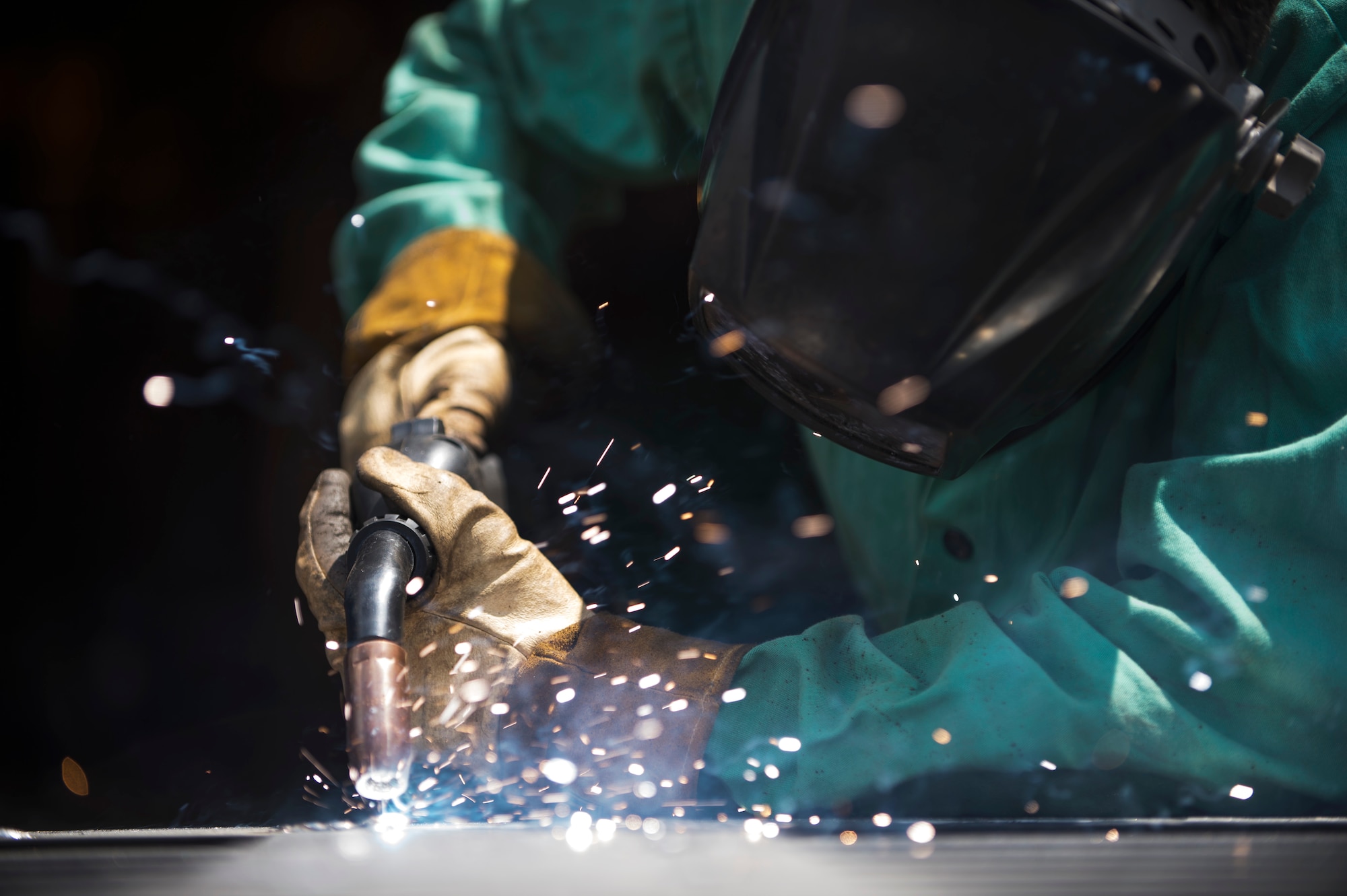 Airman 1st Class Justin Cox, 11th Civil Engineer Squadron structural apprentice, welds a connection to a base gate outside the metal workshop on Joint Base Andrews, Md., June 1, 2016. The structures section of the 11th CES worked 116 jobs in the month of May that included preventive maintenance, lock jobs and repairs throughout base. (U.S. Air Force photo by Airman 1st Class Philip Bryant)