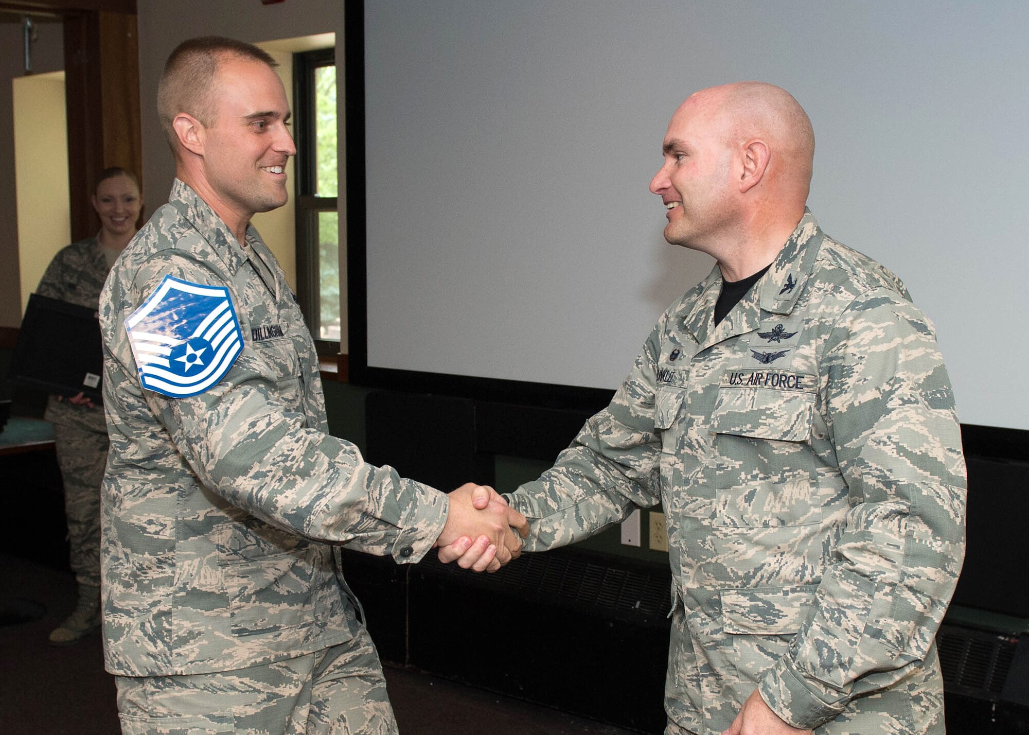 Col. David R. Dunklee, installation commander, congratulates Tech. Sgt. Ryan T. Dillingham, 66th Air Base Group Safety NCO in charge, on being selected for promotion to master sergeant during a recognition ceremony at the Minuteman Commons June 3. Dillingham and eight other Airmen assigned to Hanscom were selected for promotion to master sergeant in May. (U.S. Air Force photo by Jerry Saslav)