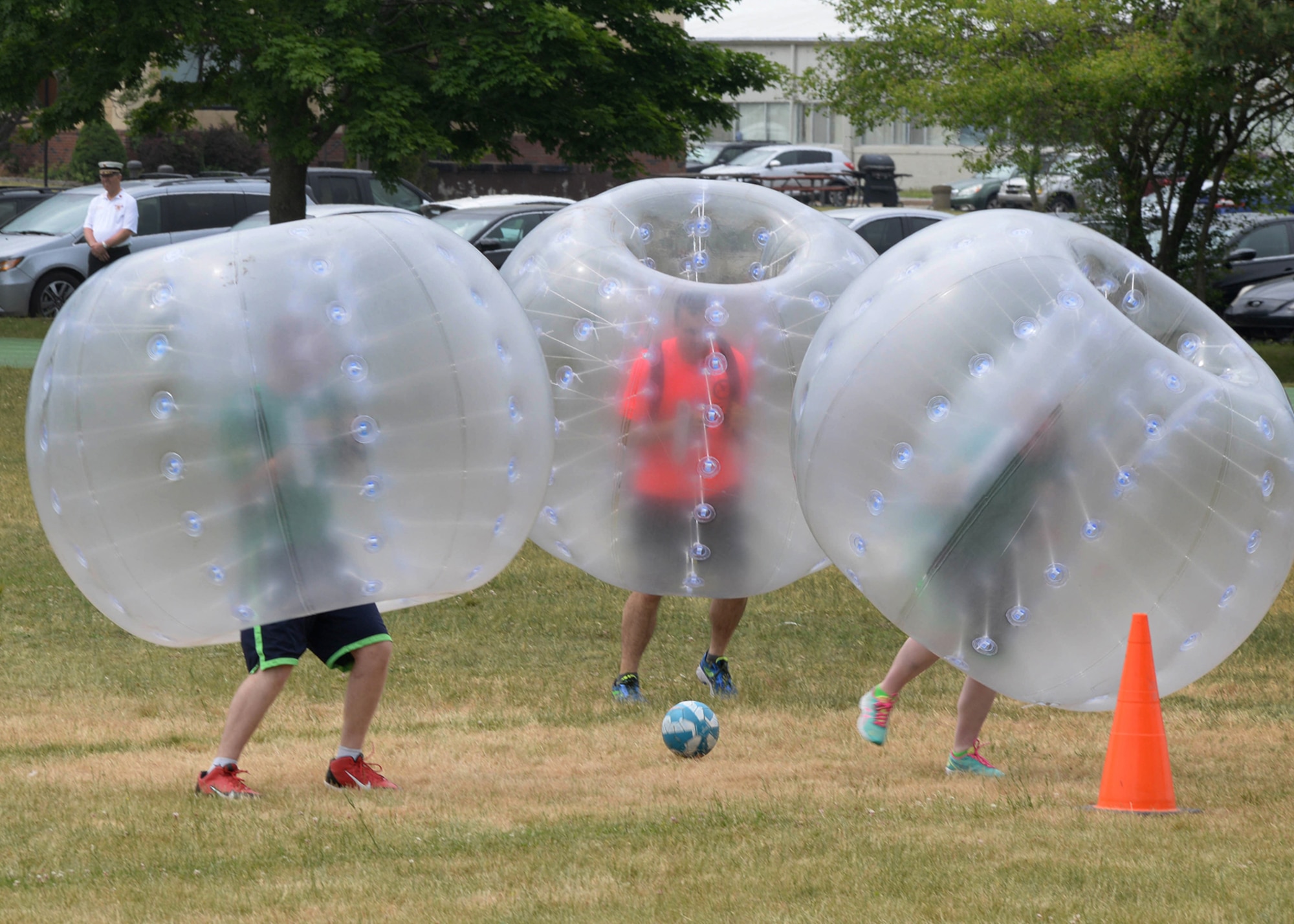 Members of the 66th Security Forces Squadron and 66th Comptroller Squadron participate in a bubble soccer match at the base track June 3. SFS beat CPTS by a score of 3 to 0 to win the bubble soccer championship. The Hanscom-based Air Force Sergeants Association planned the event as part of the Hanscom Summer Games. (U.S. Air Force photo by Mark Herlihy)