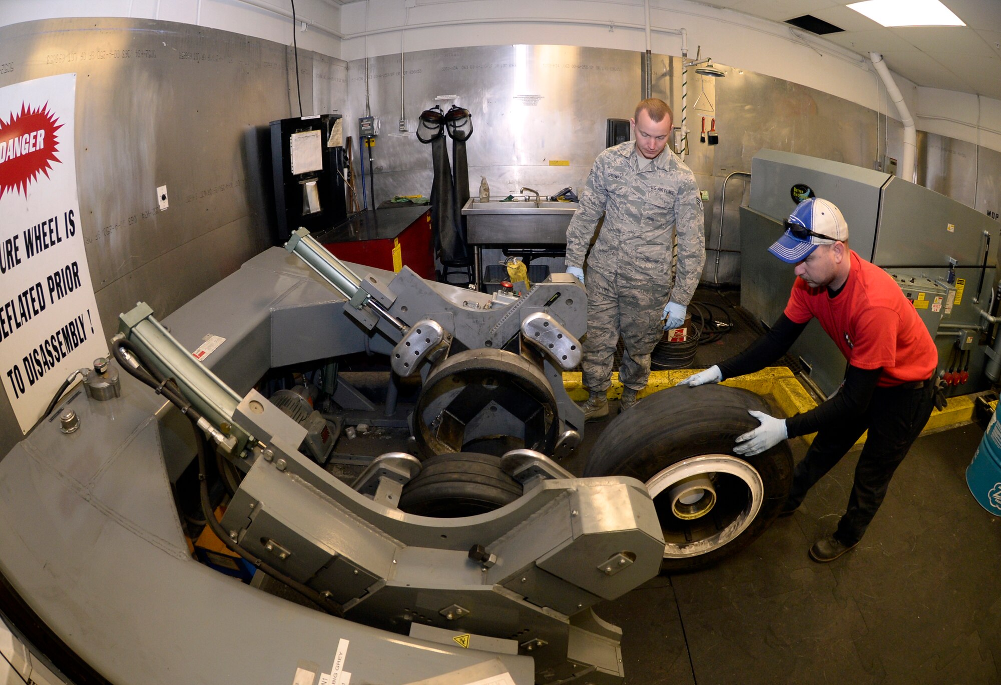 Tech. Sgt. James Speicher, an Air Reserve Technician with the 419th Maintenance Squadron, rolls an F-35 wheel into a tire-changing machine May 20 in the wheel and tire shop at Hill Air Force Base, Utah. The tire-changing machine depicted is a legacy tool which has been adapted via a fabricated bead breaker to be used in changing F-35 tires. Senior Airman Joseph Sprowls, 388th Maintenance Squadron, looks on. (U.S. Air Force photo by Todd Cromar)
