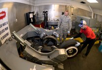 Tech. Sgt. James Speicher, an Air Reserve Technician with the 419th Maintenance Squadron, rolls an F-35 wheel into a tire-changing machine May 20 in the wheel and tire shop at Hill Air Force Base, Utah. The tire-changing machine depicted is a legacy tool which has been adapted via a fabricated bead breaker to be used in changing F-35 tires. Senior Airman Joseph Sprowls, 388th Maintenance Squadron, looks on. (U.S. Air Force photo by Todd Cromar)