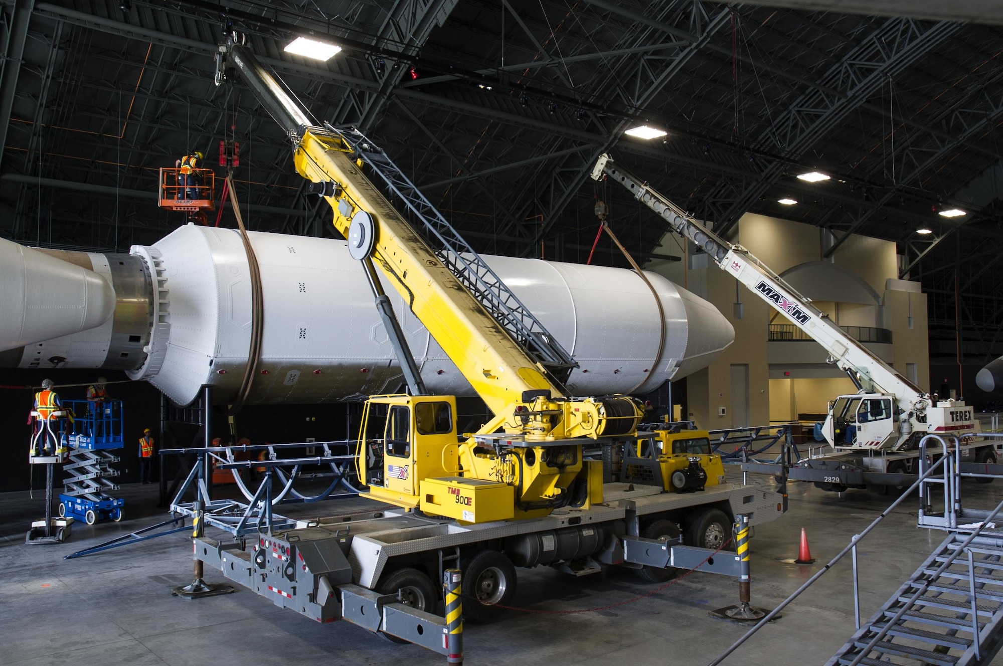 DAYTON, Ohio - Titan IVB stage two, and the payload fairing were both raised into their final position from May 12-13, 2016. Maxim Crane Works and museum restoration crews worked together using two lifts to place the final sections onto the stand. The impressive Titan IVB, with roots going back to the early days of U.S. Air Force and civil space launch, is significant as the museum looks to share the story of USAF and USAF-enabled space operations in its Space Gallery. The Titan IVB will be on display in the new fourth building at the National Museum of the U.S. Air Force which opens to the public on June 8. (U.S. Air Force photo by Ken LaRock) 