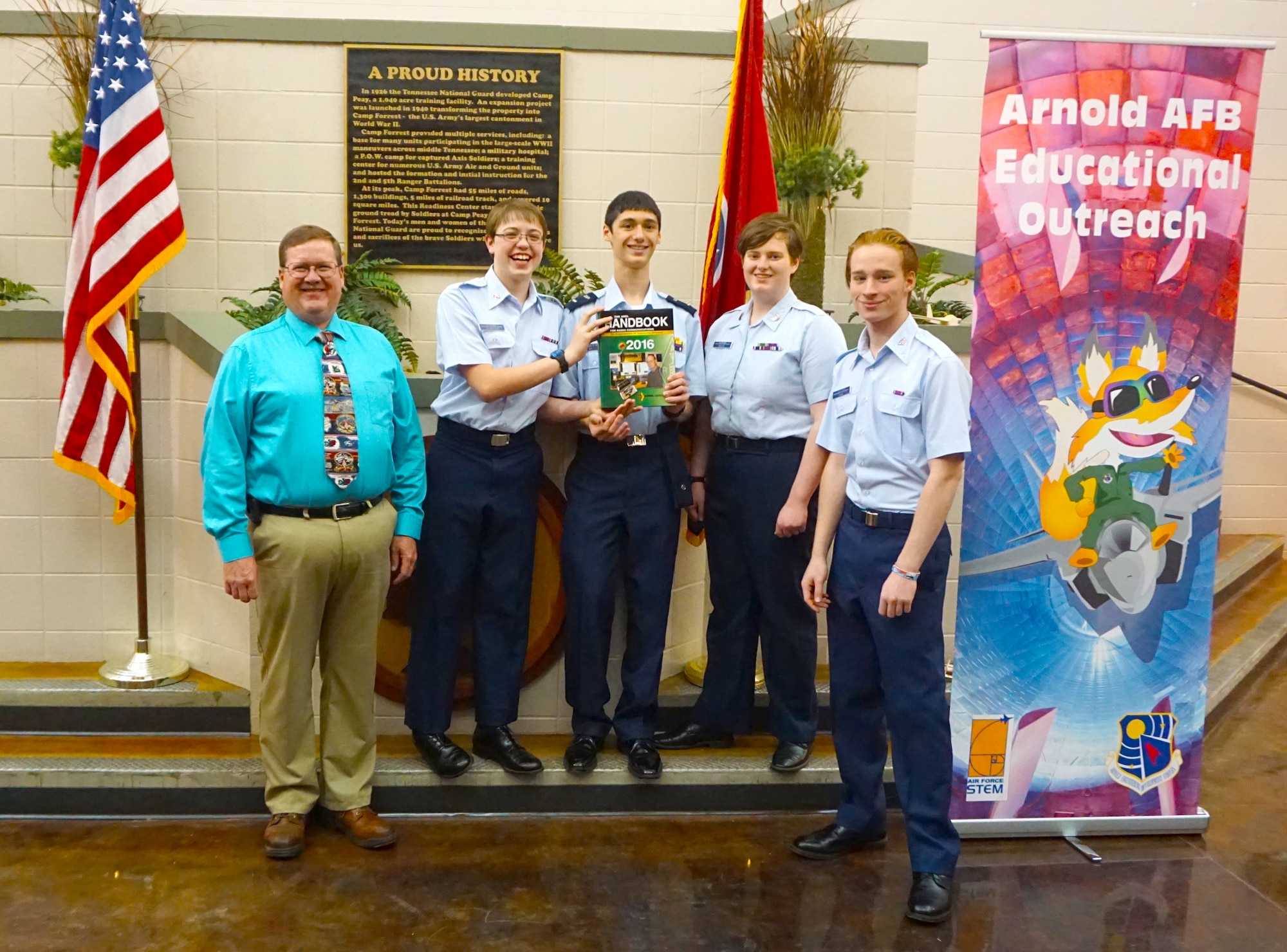 Michael Glennon (far left), technical director of AEDC Engineering and Technical Management, presents an Amateur Radio Relay League handbook to the Tullahoma Civil Air Patrol Composite Squadron May 23, recognizing their STEM electronic and robot program. Pictured with Glennon left to right is Hayden Thompson, William Watters, Brenan Bailey and William Lore. The book was presented on behalf of the AEDC amateur radio members who support STEM efforts with the group. AEDC STEM program also supports the Tullahoma CAP. (Courtesy photo)
