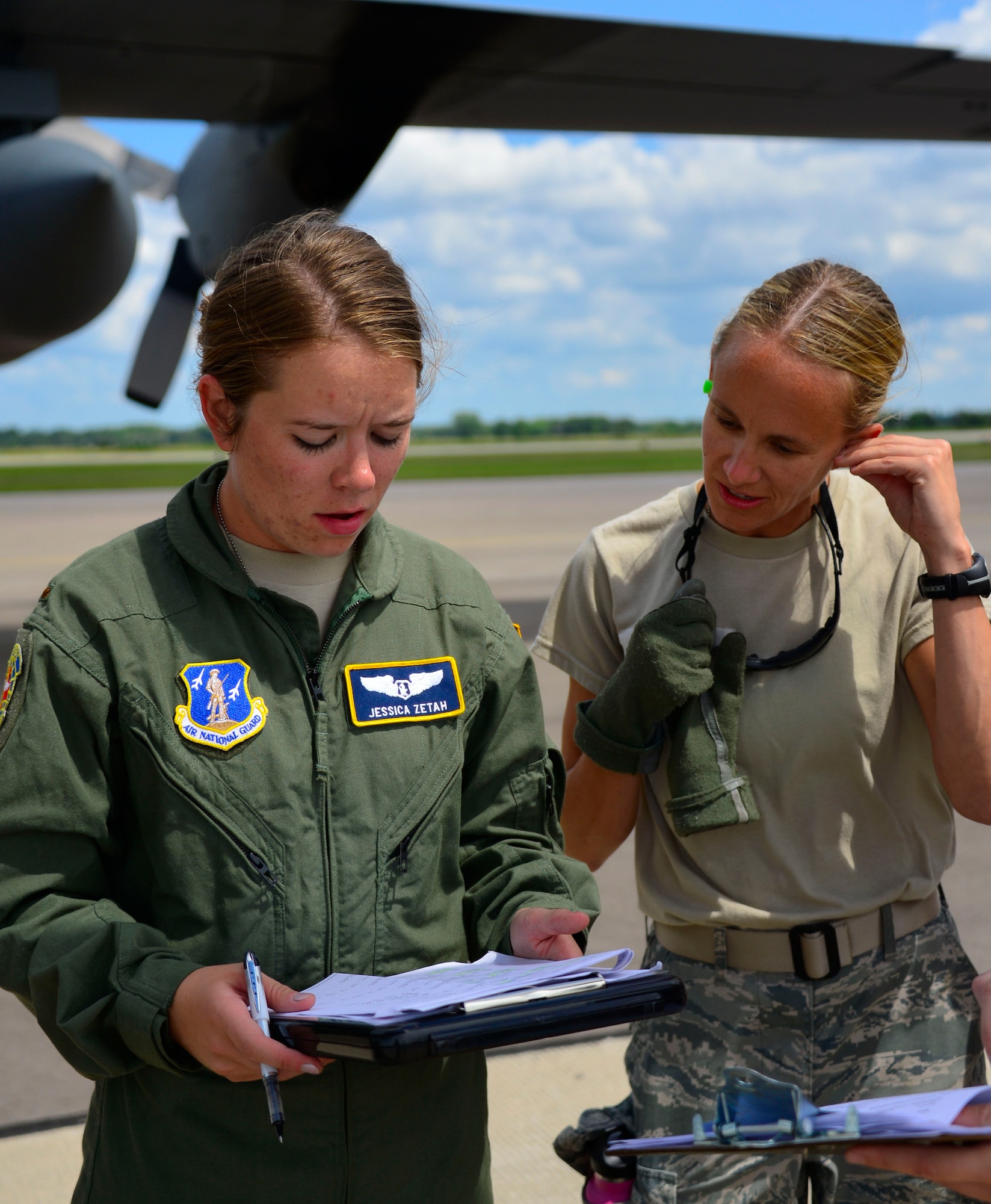 U.S. Air Force 2nd Lt. Jessica Zetah, left, receives patient information from Capt. Amy Nordquist at Volk Field Combat Readiness Training Center, Wis., July 22, 2015. Zetch and Nordquist are taking part in the annual PATRIOT Exercise, a domestic operations disaster-response training exercise conducted by National Guard units working with state and local emergency management agencies and first responders. 
(U.S. Air National Guard photo by Tech. Sgt. Amy M. Lovgren/Released)