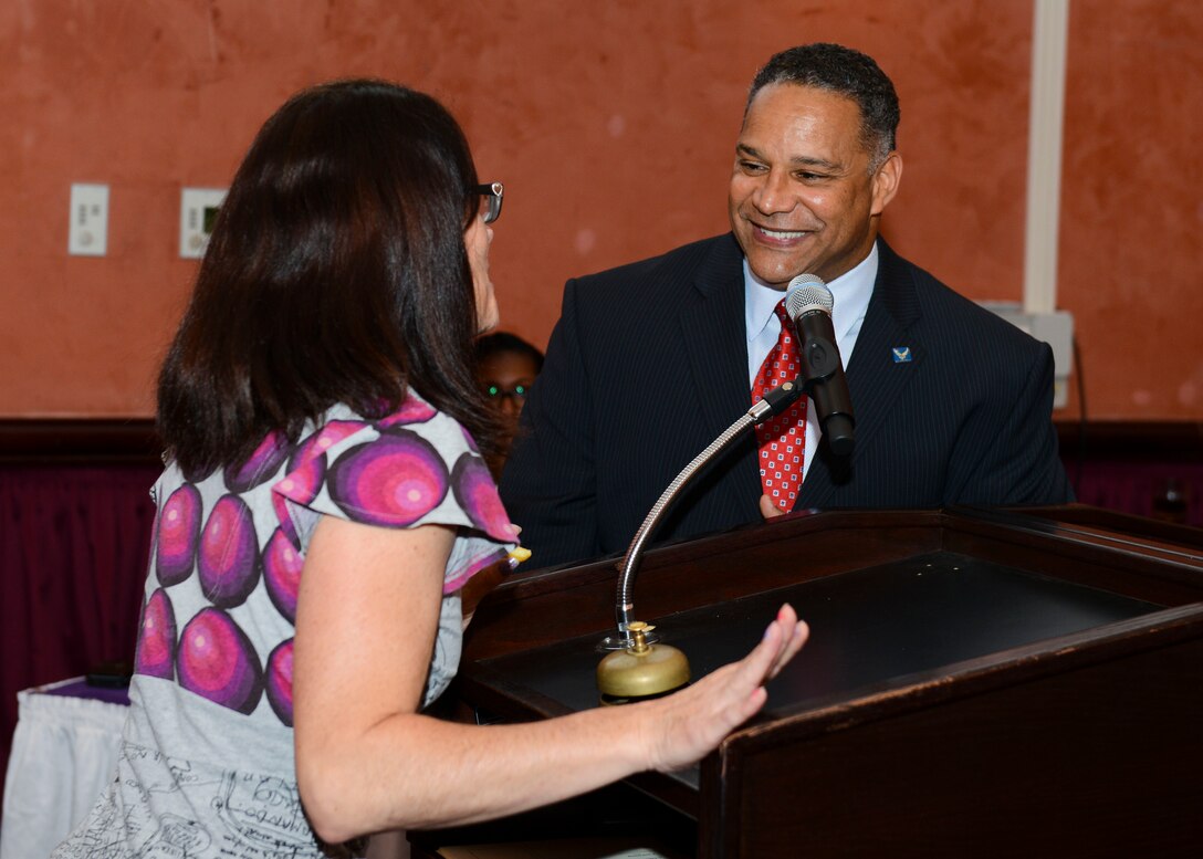 Vanessa Hale, 31st Medical Group spouse, answers a question from John Duarte, 31st Force Support Squadron key spouse and game host, during the second quarter “Spouse It Up: Family Feud” competition, June 2, 2016, at Aviano Air Base, Italy. The Airman and Family Readiness Center hosted this quarter’s event. (U.S. Air Force photo by Senior Airman Austin Harvill/Released)
